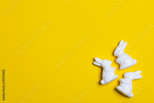 Easter bunny rabbits on a bright yellow background