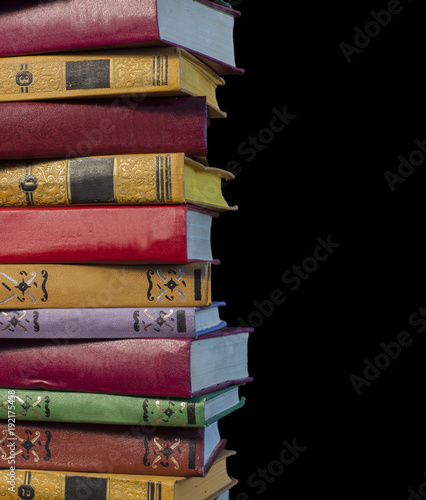 bunch of old books on a black background