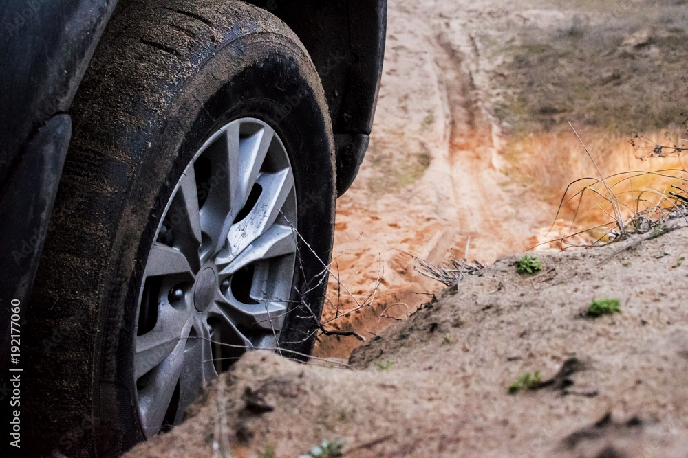 SUV tire on the background of the sandy road SUV tire on the background of the sandy road