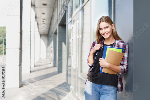 Student girl with books on university background