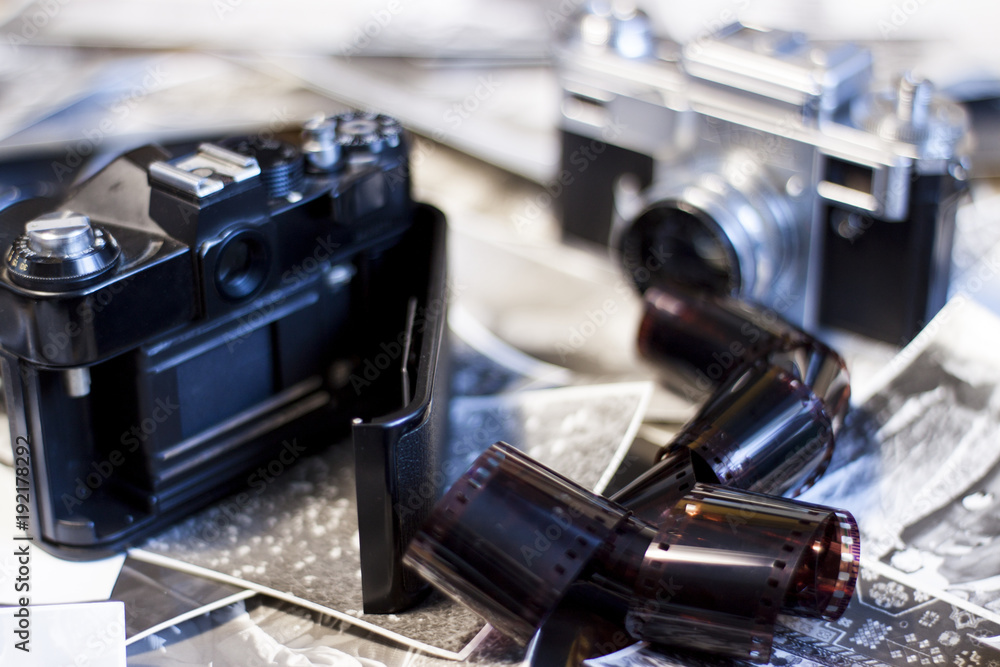 Retro camera on the table. Photographs and Photographic Film Retro camera on the table. Photographs and Photographic Film
