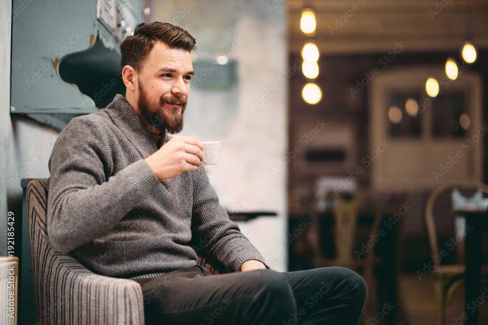 Man sitting in the chair and drinking coffee at cafe Man sitting in the chair and drinking coffee at cafe