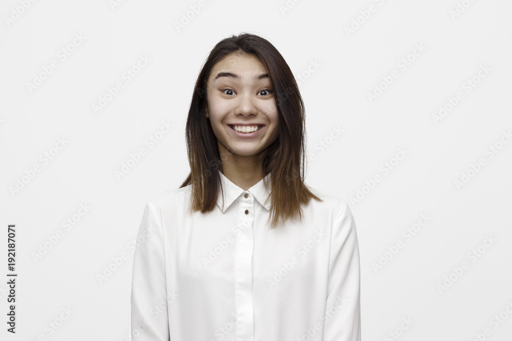 Portrait of young extremely happy woman dressed in formal white shirt on the white background. Emotions, feelings, lifestyle concept. Portrait of young extremely happy woman dressed in formal white shirt on the white background. Emotions, feelings, lifestyle concept.