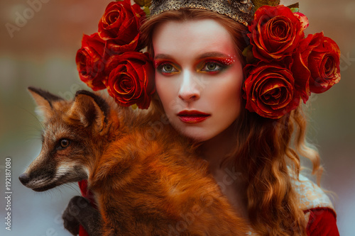 Fotografie Woman in medieval clothes with a fox