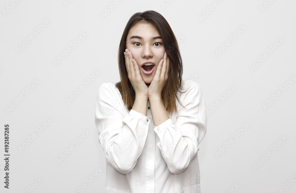 Indoor shot of shocked elegant woman in formal style looks with wide eyed expression being horrified to find out something bad, wonders how it happened. Shocking news Indoor shot of shocked elegant woman in formal style looks with wide eyed expression being horrified to find out something bad, wonders how it happened. Shocking news