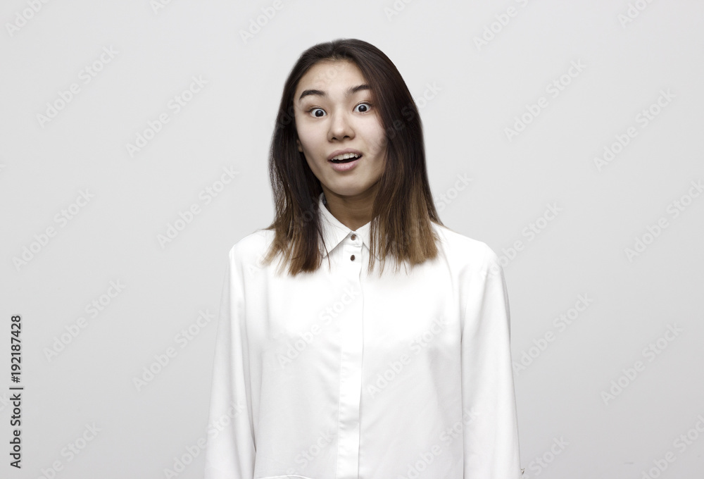 Indoor shot of shocked elegant woman in formal style looks with wide eyed expression being horrified to find out something bad, wonders how it happened. Shocking news Indoor shot of shocked elegant woman in formal style looks with wide eyed expression being horrified to find out something bad, wonders how it happened. Shocking news