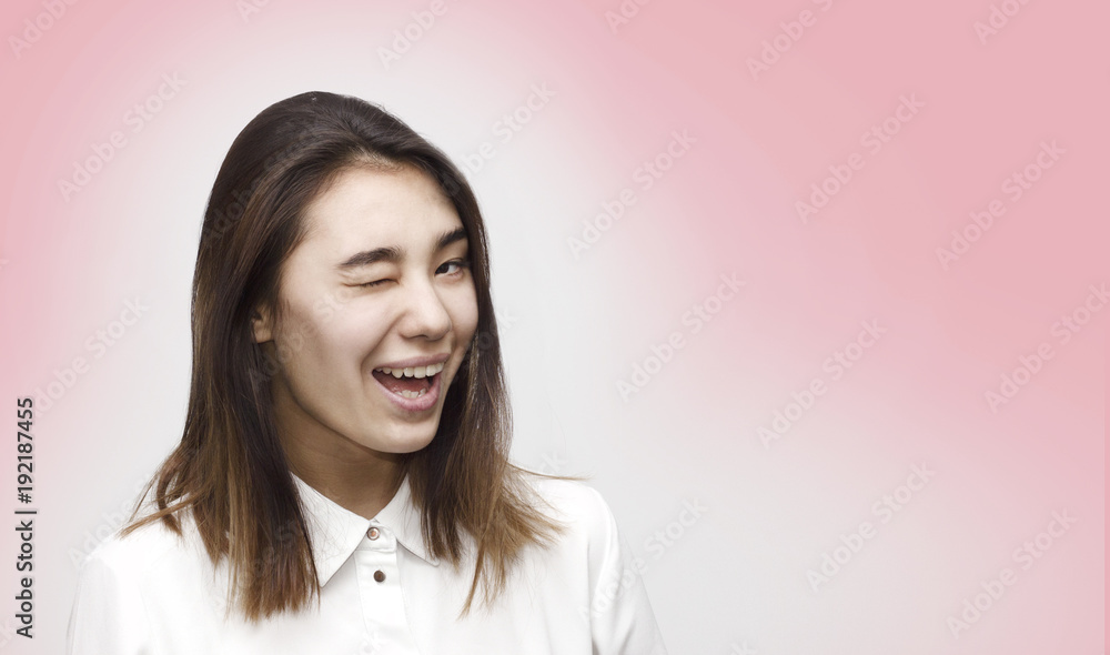 Indoor close up portrait of young attractive charming woman winking dressed in formal white shirt. Facial expressions, emotions, lifestyle concept Indoor close up portrait of young attractive charming woman winking dressed in formal white shirt. Facial expressions, emotions, lifestyle concept