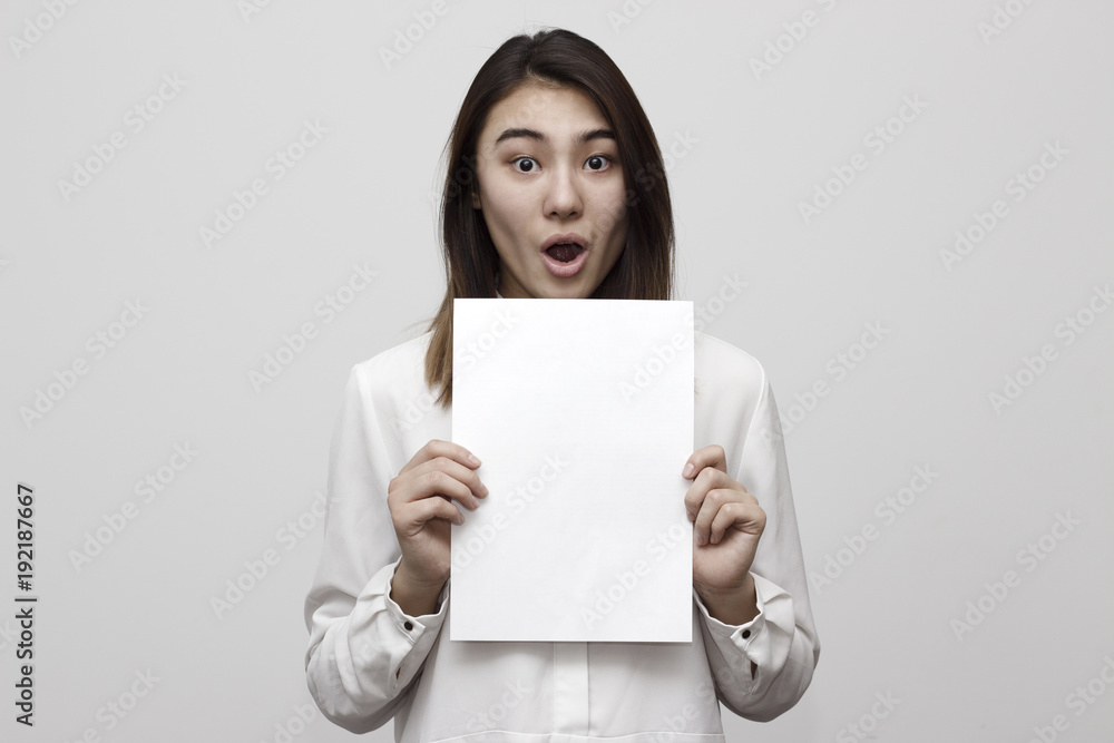Shocked young girl holding empty blank white board. Leaflet presentation. Pamphlet hold hands. Girl show clear offset paper. Sheet template. Booklet design sheet display read first person. Shocked young girl holding empty blank white board. Leaflet presentation. Pamphlet hold hands. Girl show clear offset paper. Sheet template. Booklet design sheet display read first person.
