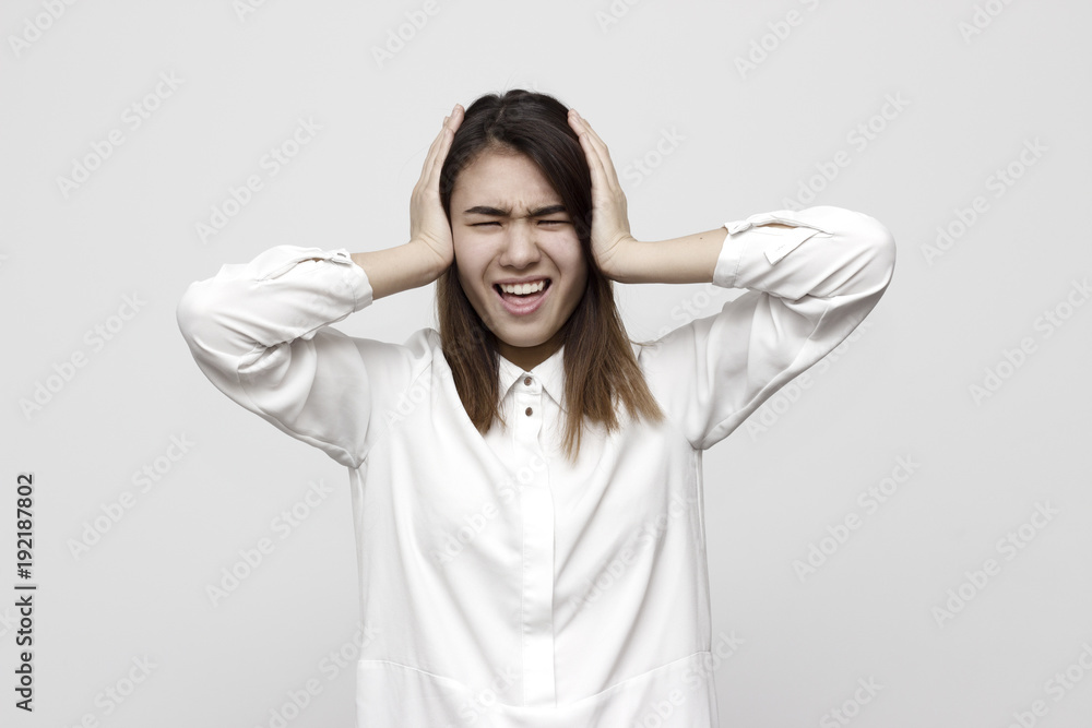 Stop it! Silence! Quiet! Close up of a stressed yelling teen with closed eyes and ears. Negative feelings and emotions concept Stop it! Silence! Quiet! Close up of a stressed yelling teen with closed eyes and ears. Negative feelings and emotions concept
