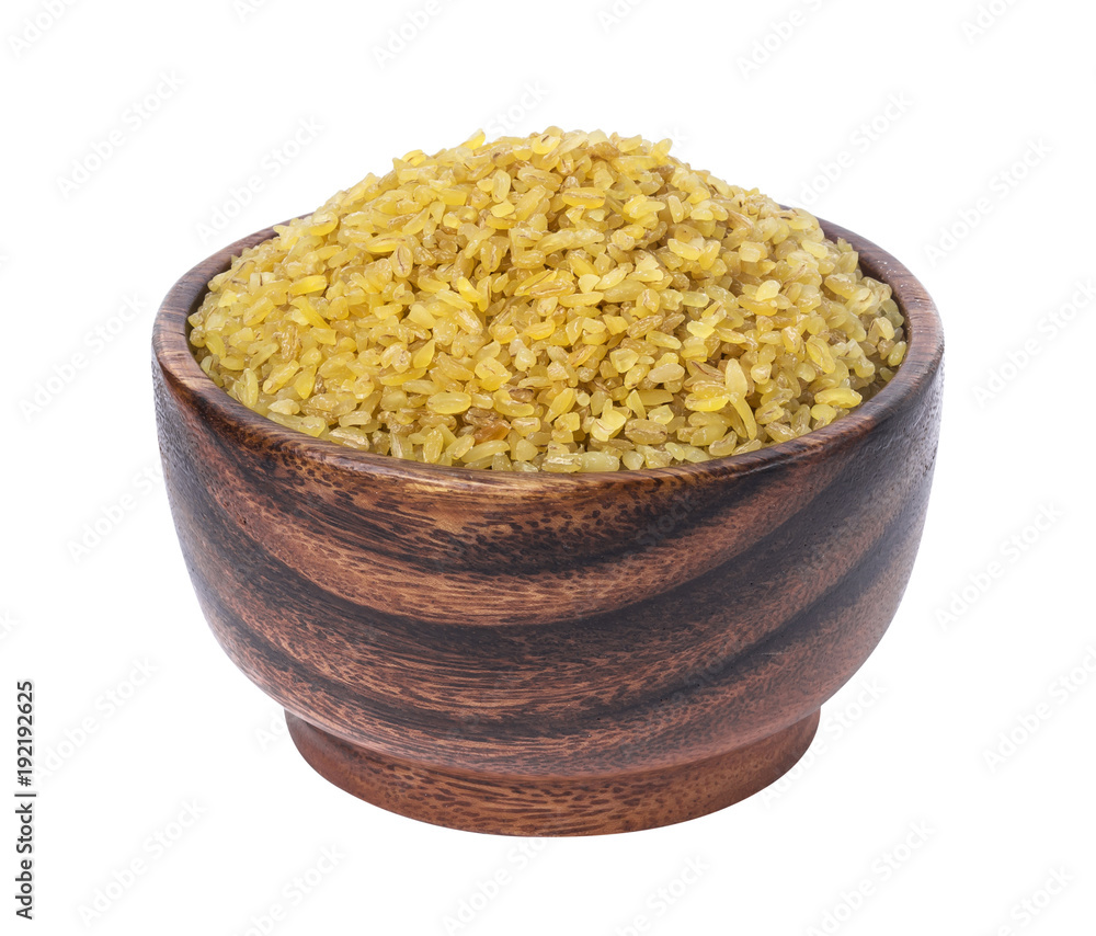 Dry bulgur wheat in wooden bowl isolated on white background Dry bulgur wheat in wooden bowl isolated on white background