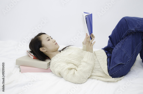 Asian women I read books on Mattress with white.