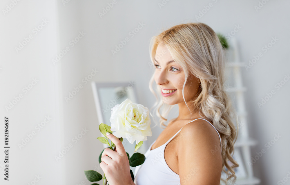 woman in underwear with rose flower at window