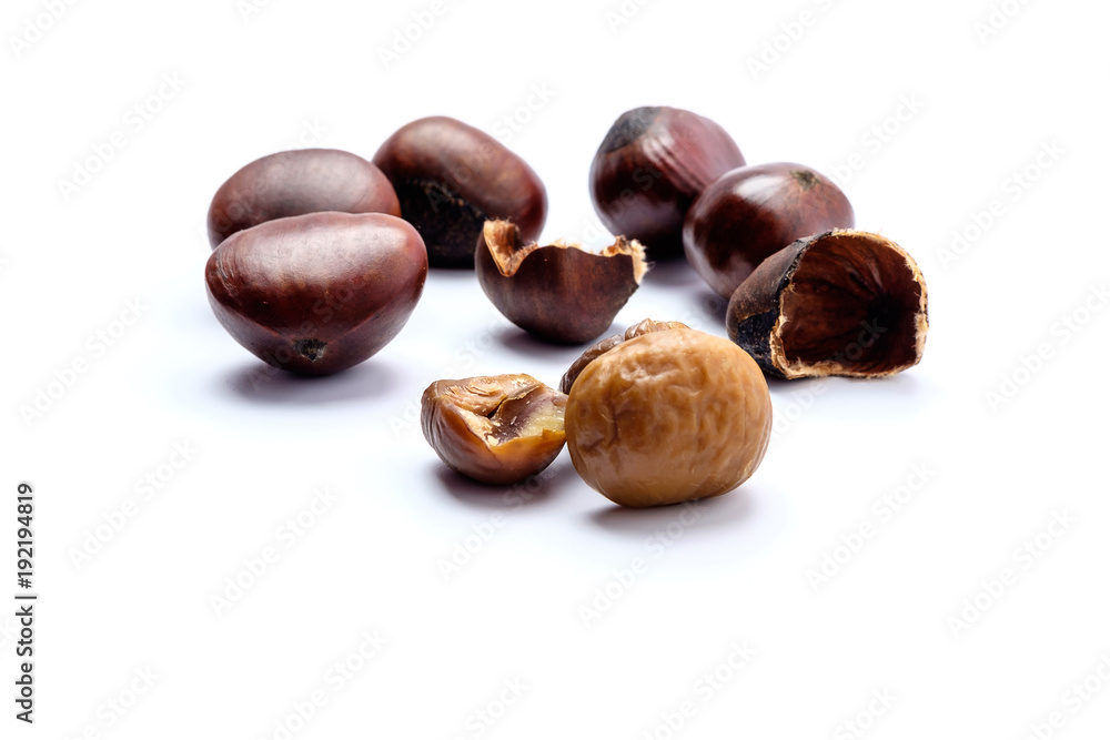Roasted chestnuts on a white background. Roasted chestnuts on a white background.