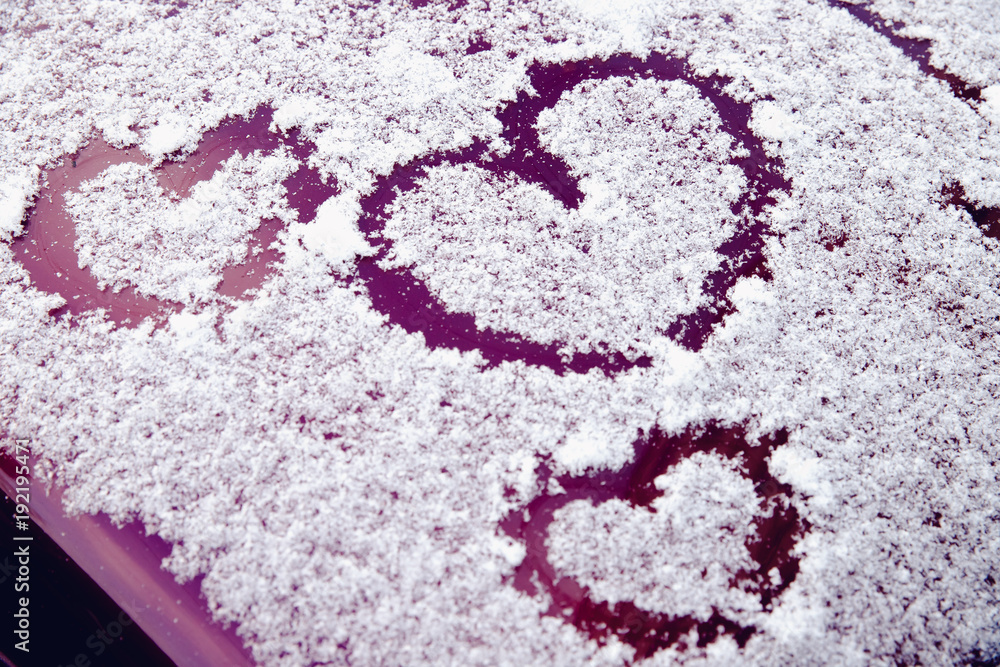 Heart of snow. Painted heart symbol on car. Concept day of St. Valentine