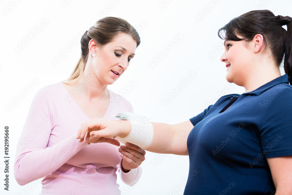 Women training in First aid course learning to apply bandages Women training in First aid course learning to apply bandages
