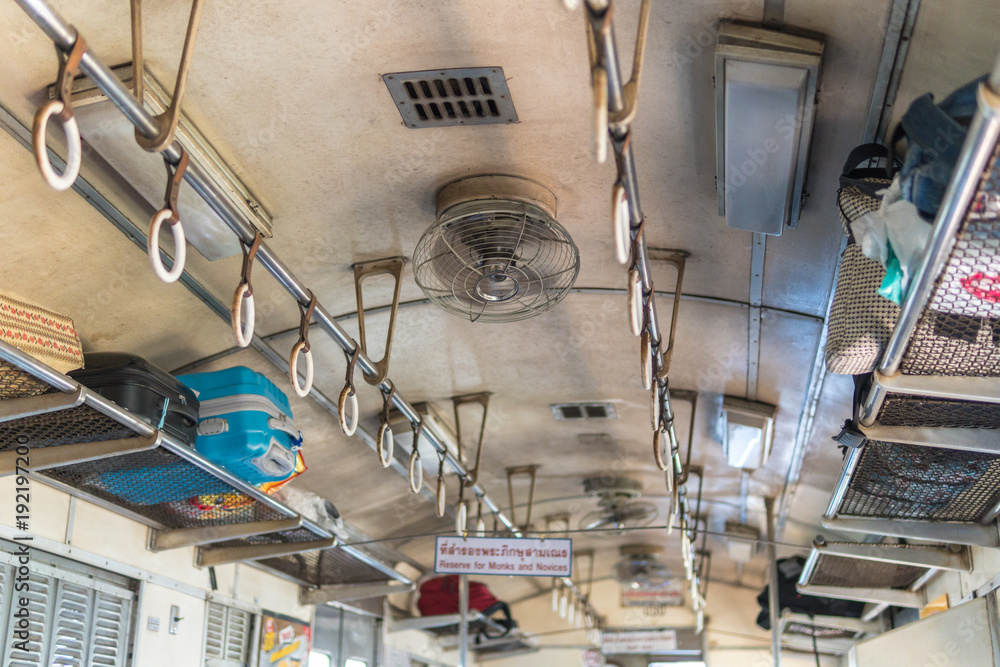 Fan and rail in Thailand vintage train cabin.