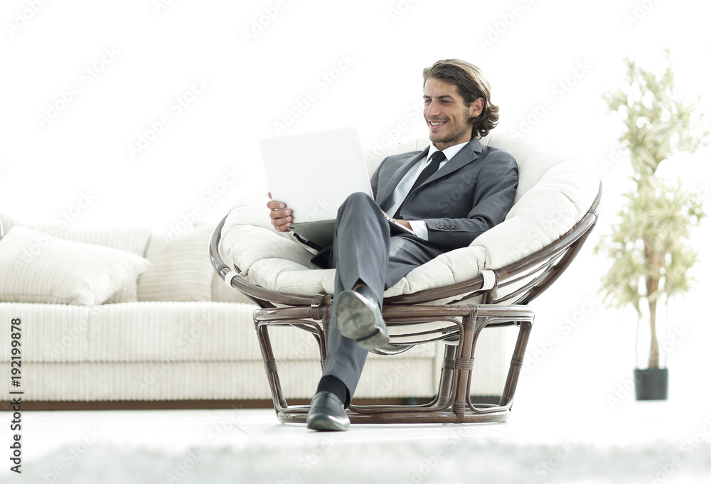 confident businessman working with laptop sitting in comfortable armchair confident businessman working with laptop sitting in comfortable armchair