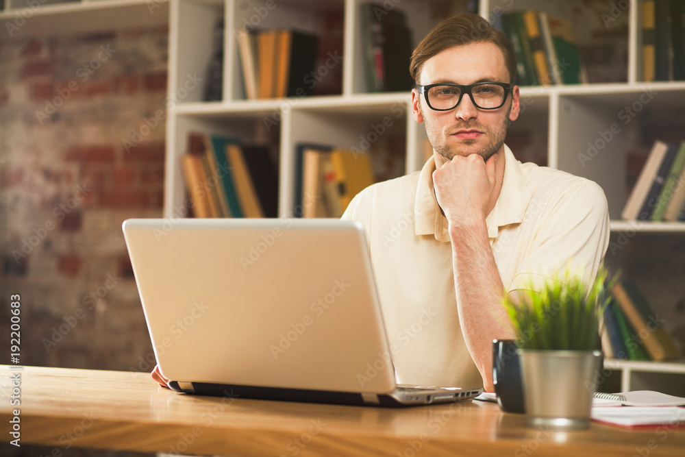 Fototapeta premium Young man with a laptop
