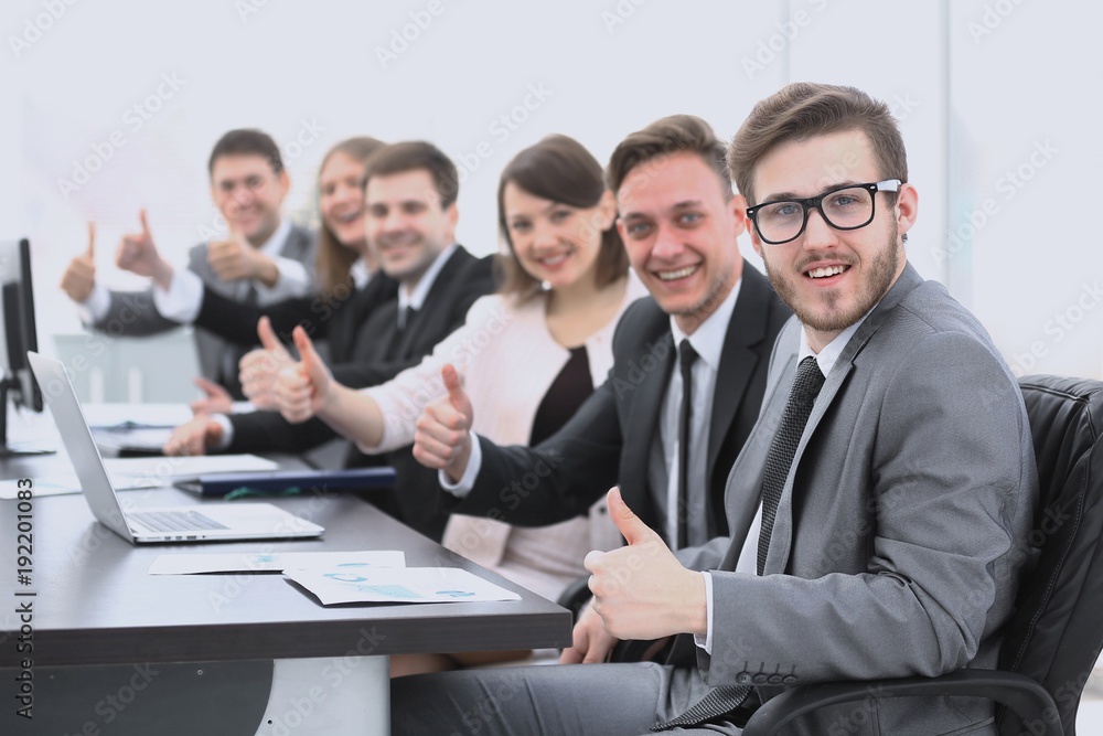business team with thumbs up while sitting at his Desk business team with thumbs up while sitting at his Desk