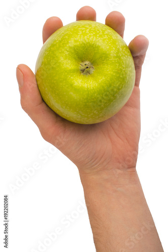 in a hand a green apple isolated on a white background