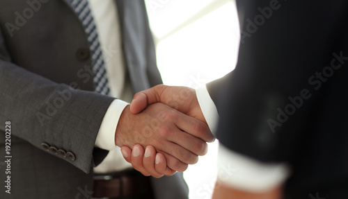 Businessman giving his hand for handshake to partner