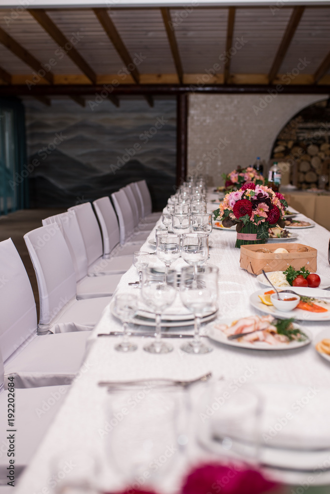 Fototapeta premium Empty glasses set in restaurant. Wineglasses served for a festive dinner. Banquet table