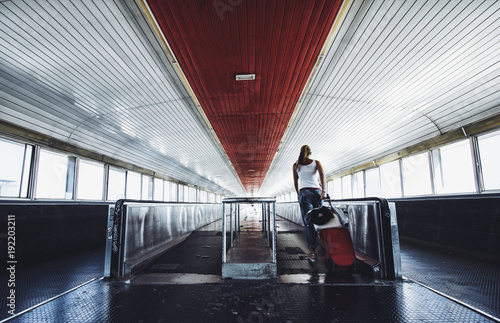 Woman with luggage on travelator