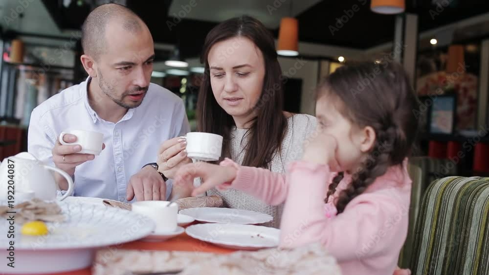 Happy family in a cafe happy to eat pizza and socialize with each other Happy family in a cafe happy to eat pizza and socialize with each other