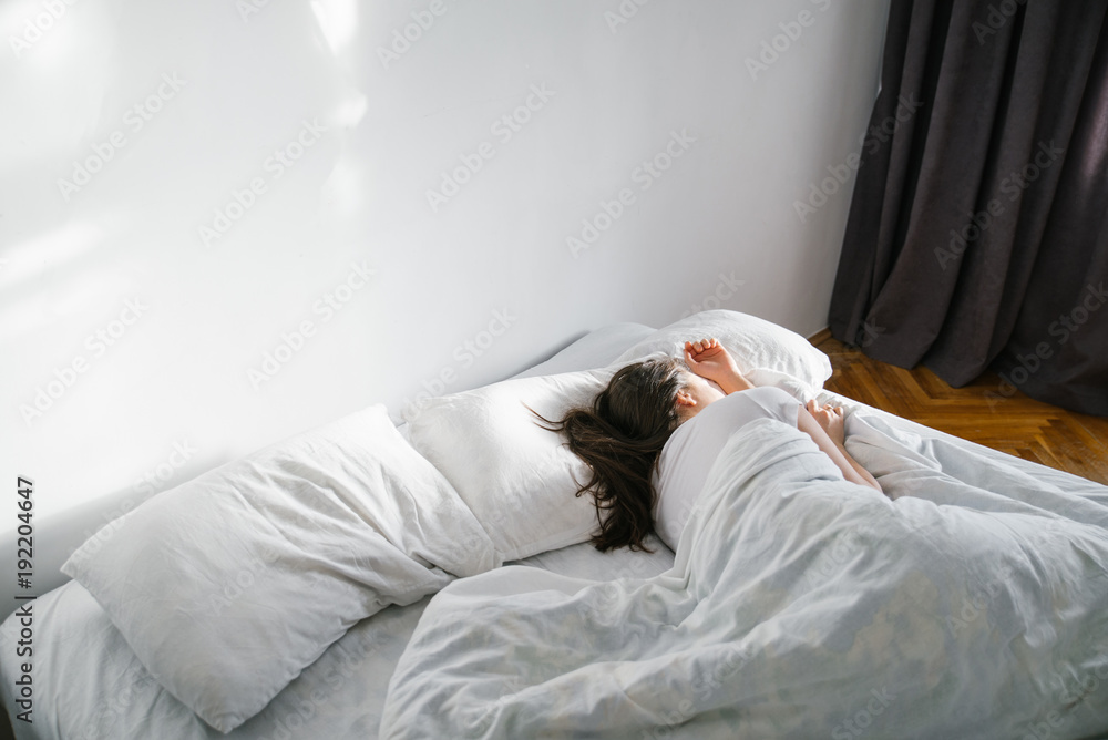 woman sleep in bed sunshine thought the window