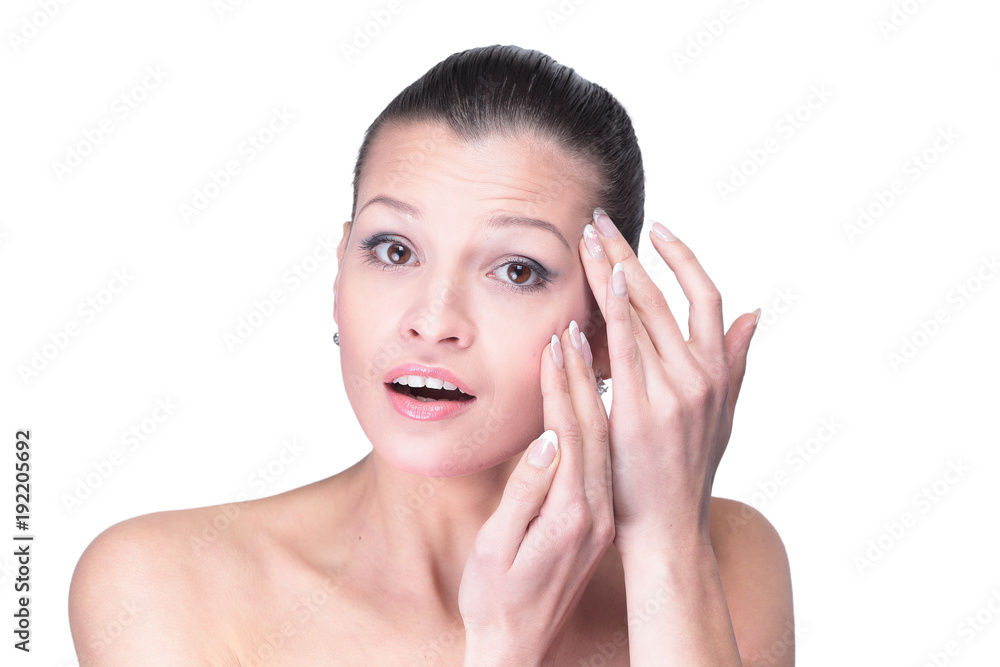 Young woman touching her face isolated on white background