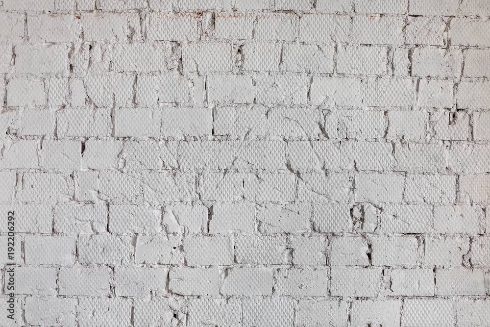 old wall from a white brick with a regular laying old wall from a white brick with a regular laying