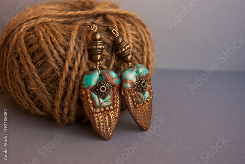 Bohemian earrings in indian style. Handmade jewelry of polymer clay. Unique bakcground fashion. photo