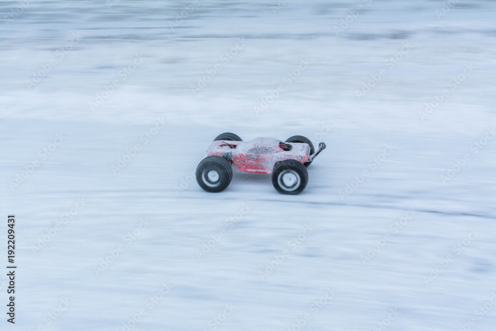 Toy sports cars on winter rally. Motion blur