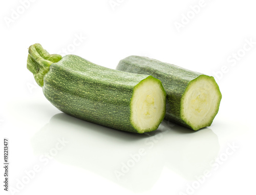 Two green zucchini halves isolated on white background long raw courgette.