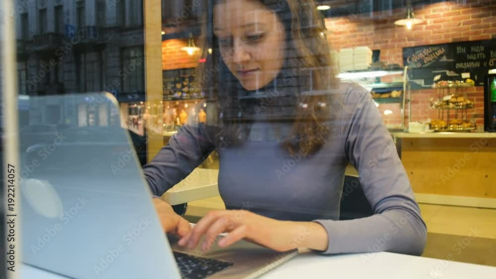 Girl opens a laptop in a cafe, 4k. Girl opens a laptop in a cafe, 4k.