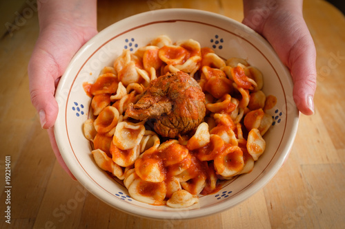 Typical Apulia region Sunday main course: fresh pasta orecchietta and meat roll braciola with tomato sauce photo