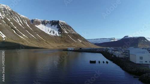 Flying over remote Icelandic city and fjord at sunset photo