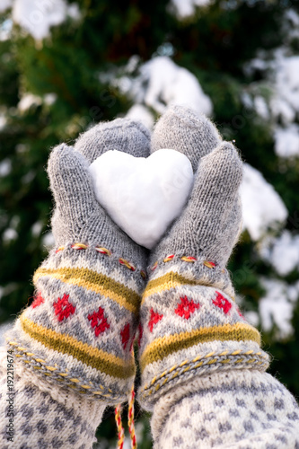 Holding a heart shaped snowball