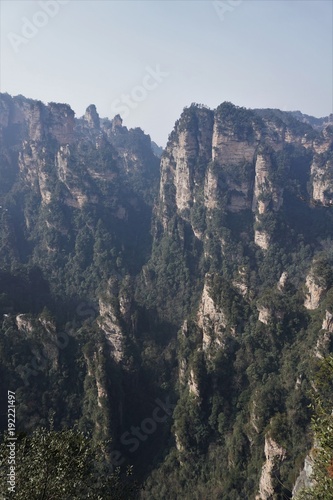 Mountains in China with trees and dust in sunshine
