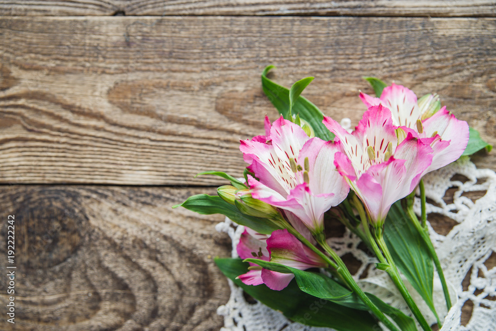 bouquet of pink flowers of Alstroemeria on wooden background