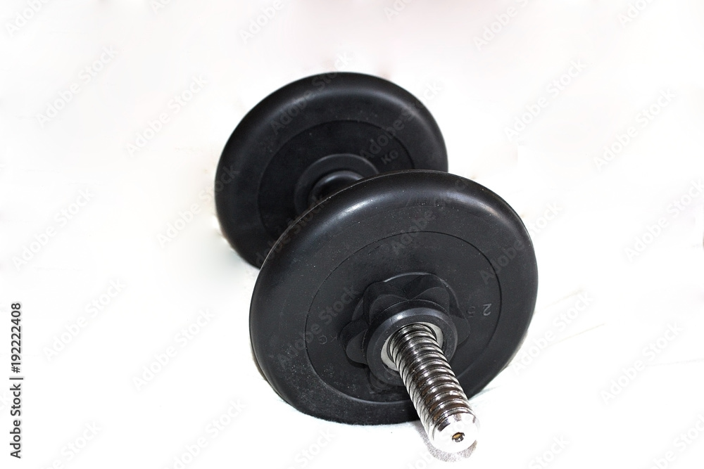Black big dumbbells, on a white background. Close-up Black big dumbbells, on a white background. Close-up