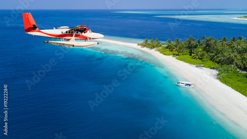 Tablou canvas Seaplane flying above exotic iceland in Maldives.