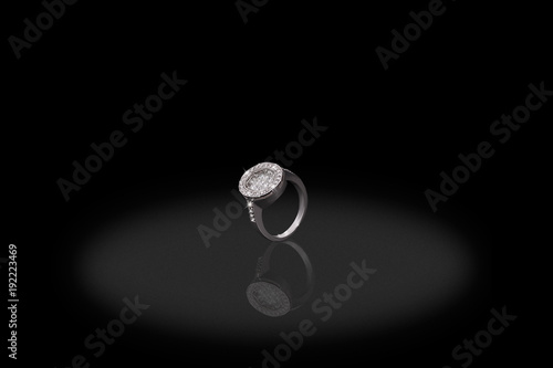 Silver precious ring female with diamonds on black background. Good material for design jewelery.
