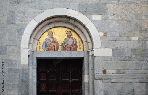 Photos ancient luxury mosaic of saint peter and saint paul above old wooden door in the
