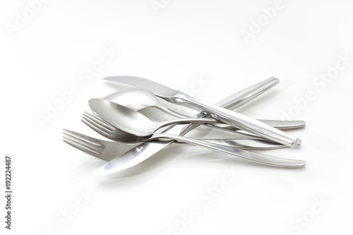 Messy set of knife spoon and fork on a white background