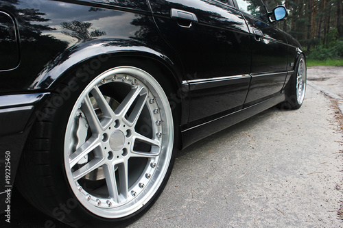 Car wheels close up on a background of asphalt. Car tires. Car wheel close-up © Stasiuk