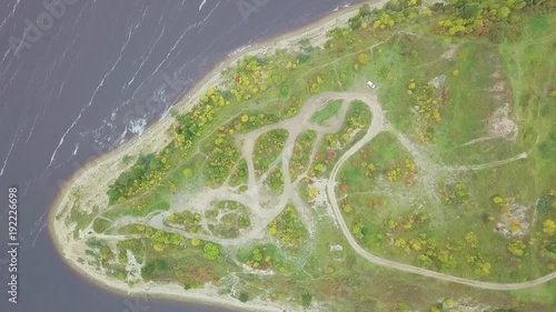 Aerial view on edge of peninsula. Clip. Rocky cape and blue sea. The view from the bird's eye view. Aerial view on rocky coast at sea archipelago photo