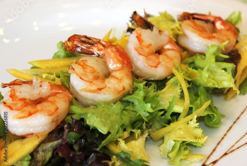 appetizing prawns with greens and cheese close-up