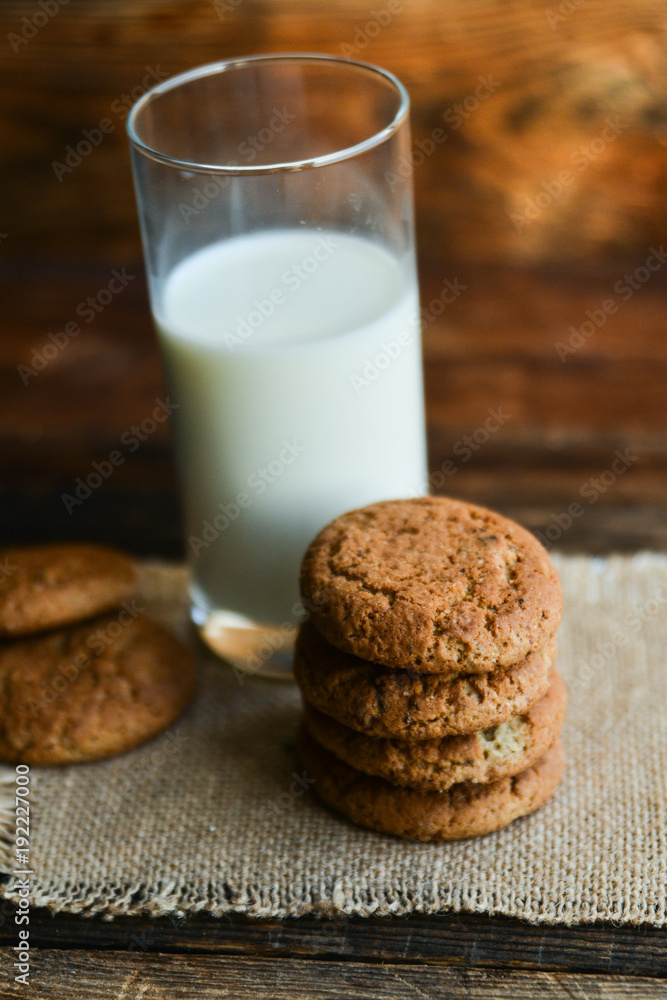 fresh oatmeal cookies and milk on wooden background with spikes of oats fresh oatmeal cookies and milk on wooden background with spikes of oats