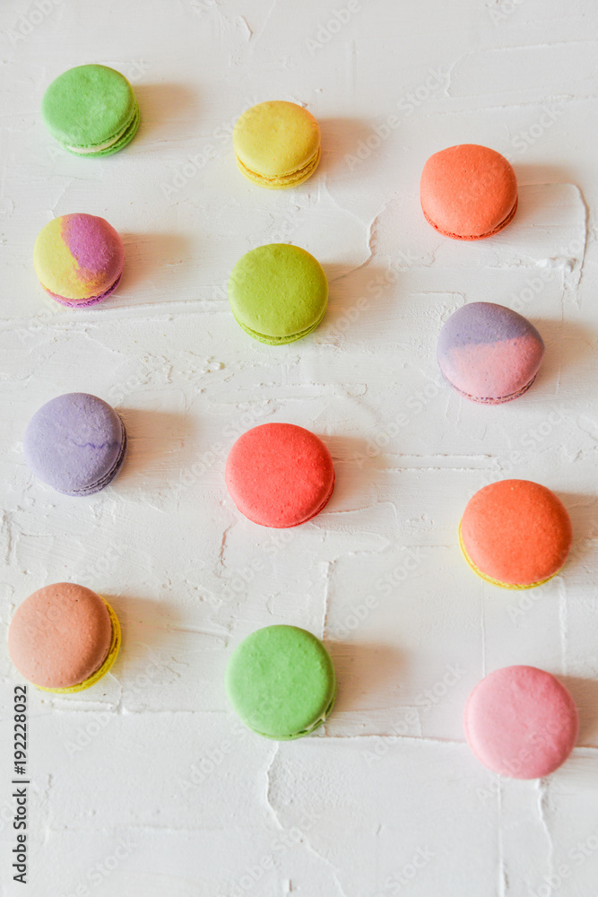 multicolored macaroons on light background, geometric layout multicolored macaroons on light background, geometric layout